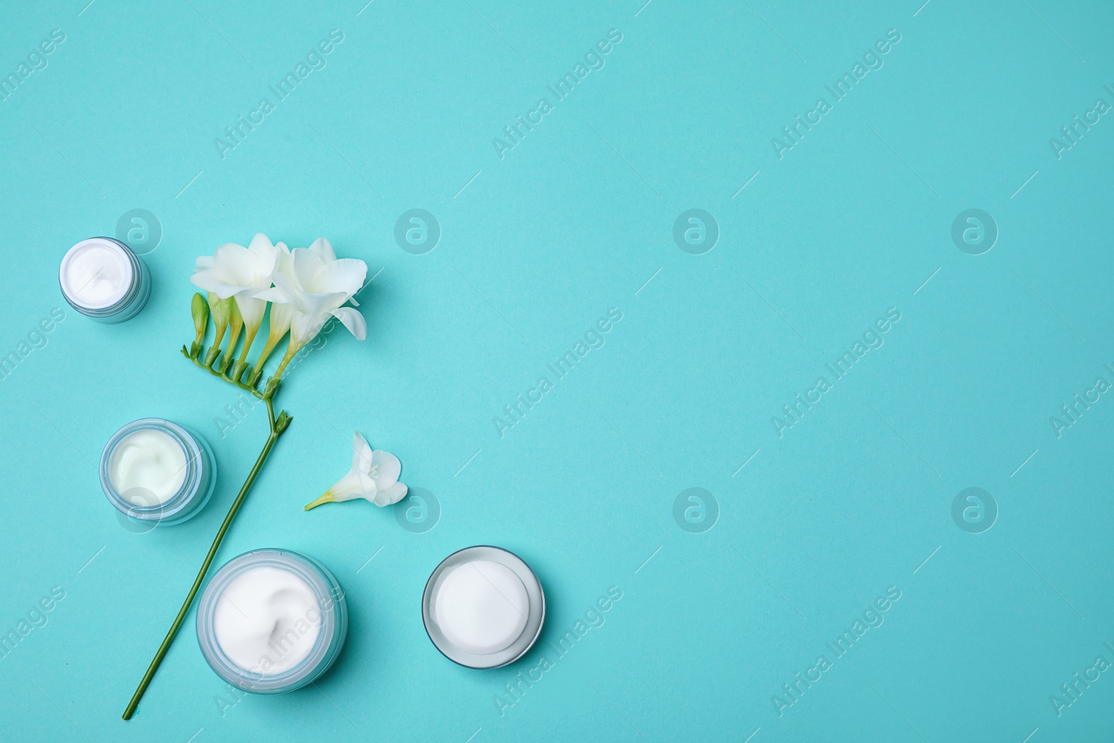 Photo of Flat lay composition with cosmetic products on color background