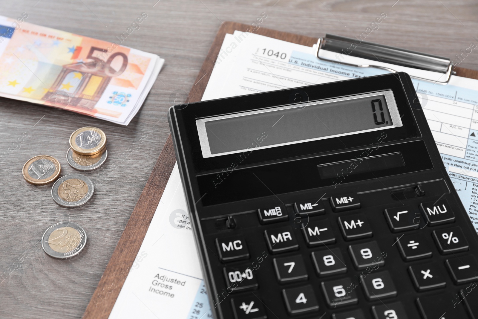 Photo of Tax accounting. Calculator, document and money on wooden table, closeup