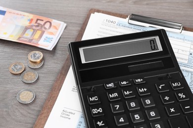 Photo of Tax accounting. Calculator, document and money on wooden table, closeup