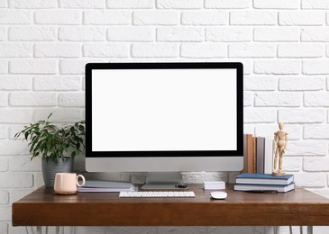 Photo of Cozy workspace with modern computer on wooden desk