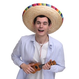 Young man in Mexican sombrero hat playing ukulele on white background