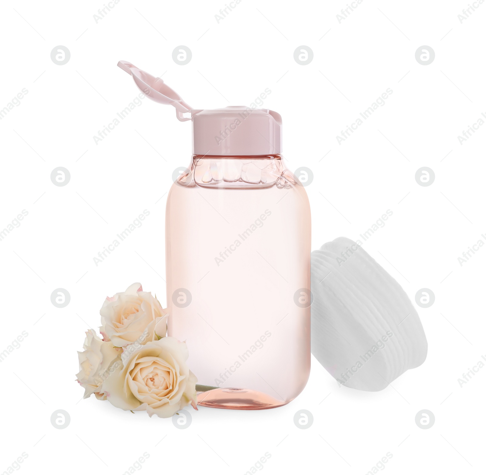 Photo of Bottle of micellar cleansing water and flowers on white background