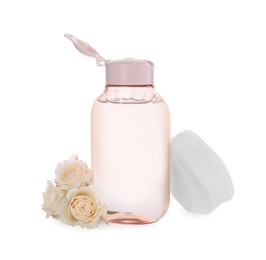 Bottle of micellar cleansing water and flowers on white background