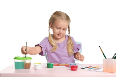 Photo of Cute child painting picture at table on white background