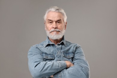 Photo of Senior man with mustache on grey background