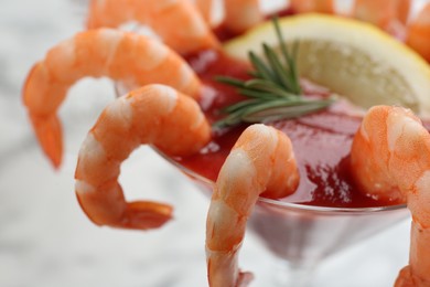 Photo of Delicious shrimp cocktail with tomato sauce, closeup