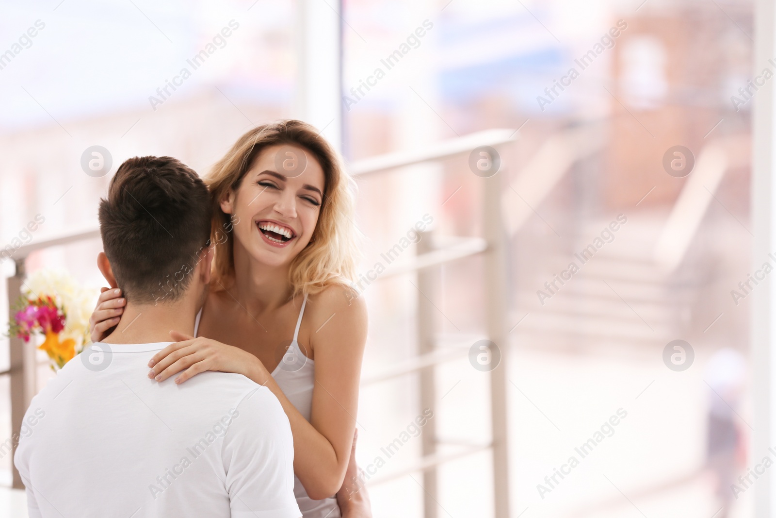 Photo of Happy young couple hugging on bed at home