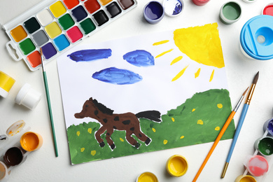 Flat lay composition with child's painting of horse on white table