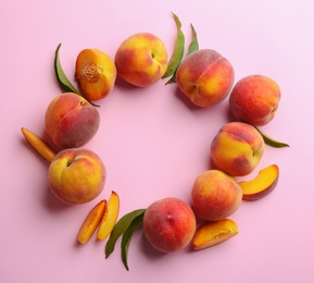 Photo of Flat lay composition with fresh peaches on pink background. Space for text