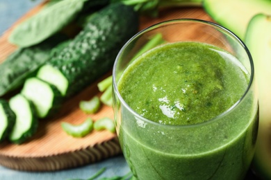 Photo of Delicious fresh green juice in glass, closeup. Space for text