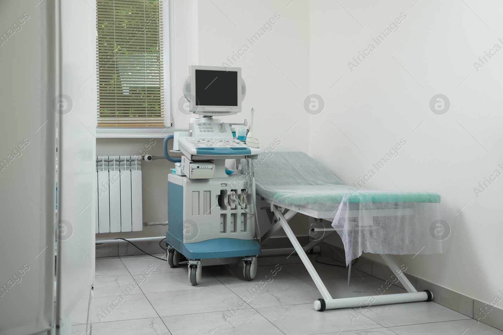 Photo of Ultrasound machine and examination table in hospital