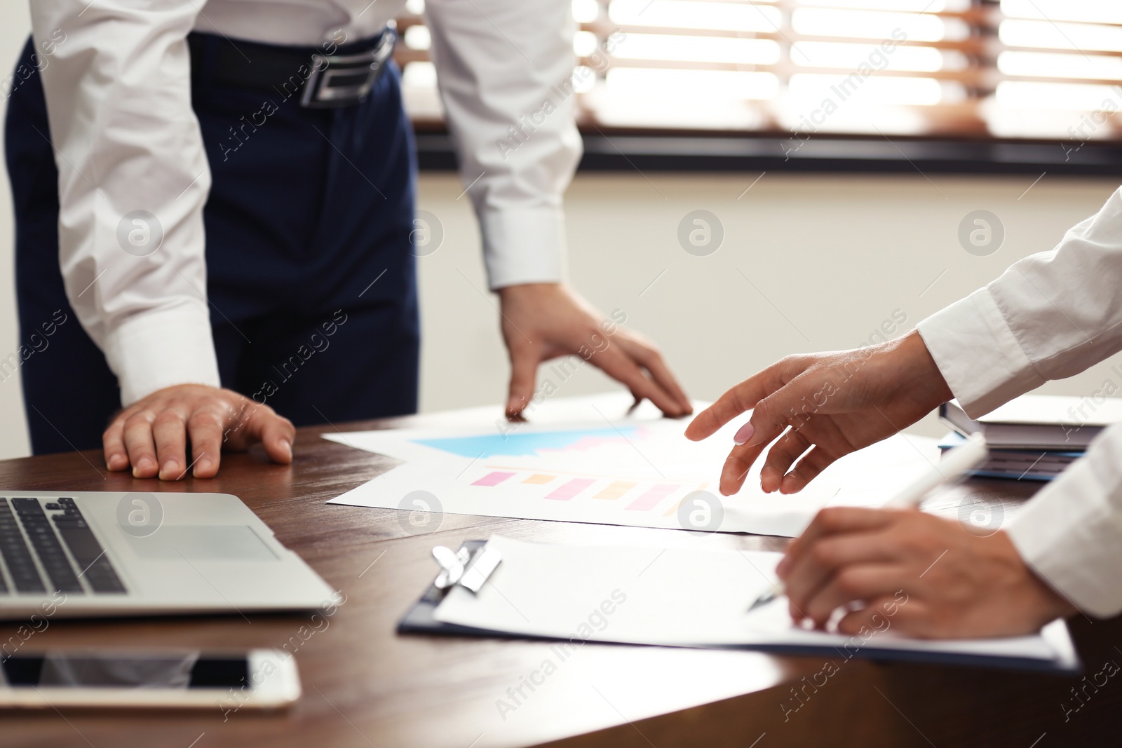 Photo of Business trainer and client working at table in office, closeup