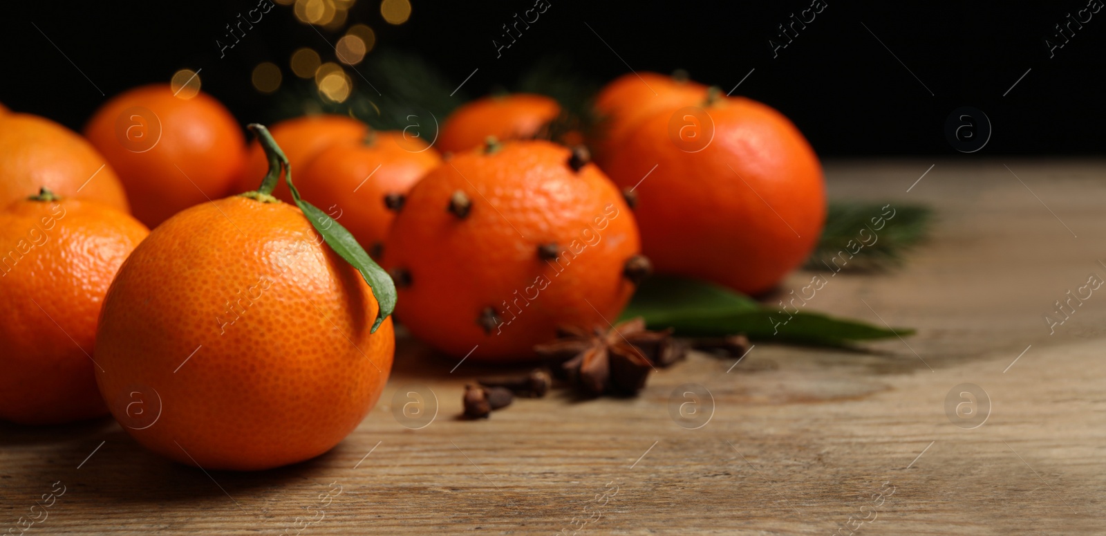 Photo of Fresh tangerines on wooden table, closeup. Christmas atmosphere