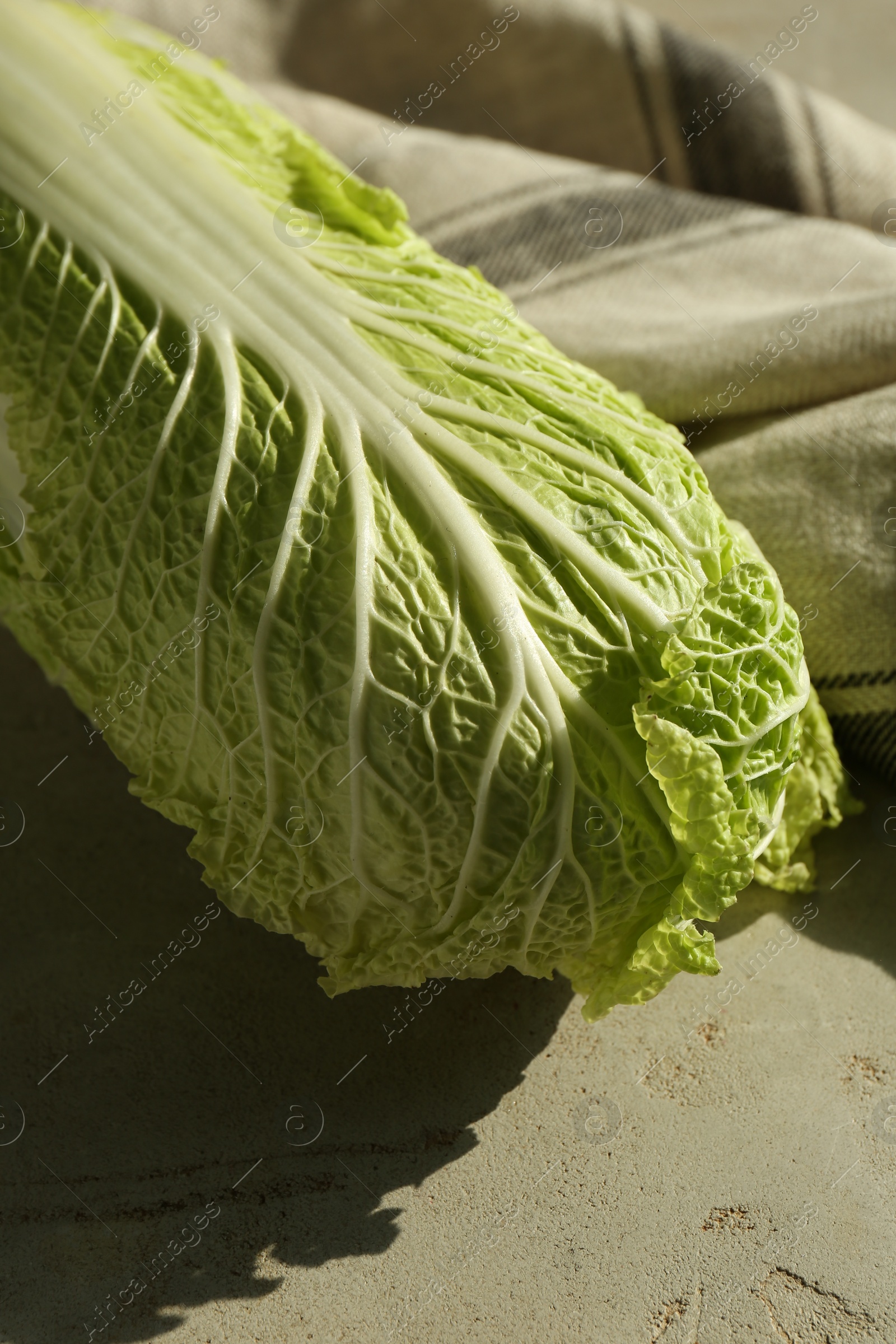 Photo of Fresh ripe Chinese cabbage on gray textured table, closeup