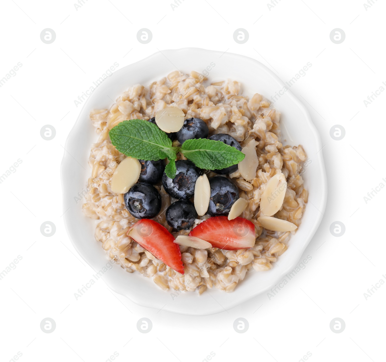 Photo of Tasty oatmeal with strawberries, blueberries and almond flakes in bowl isolated on white, top view