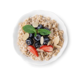 Photo of Tasty oatmeal with strawberries, blueberries and almond flakes in bowl isolated on white, top view