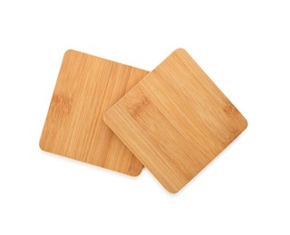 Wooden cup coasters on white background, top view