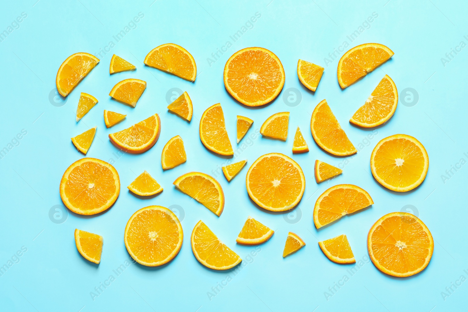 Photo of Flat lay composition with orange slices on color background