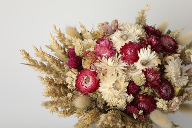 Beautiful bouquet of dry flowers on white background, closeup