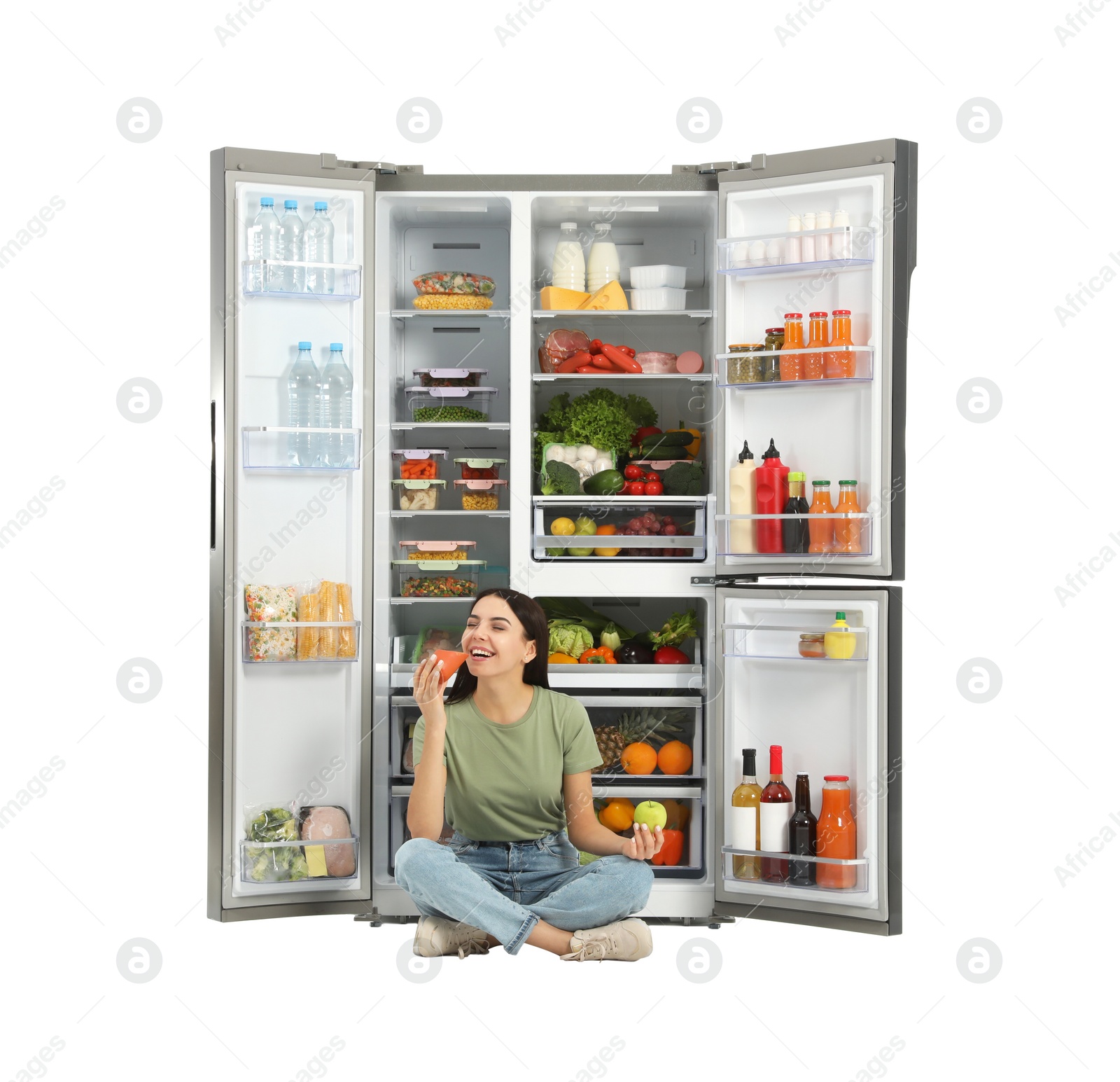 Photo of Young woman with apple and sausage near open refrigerator on white background