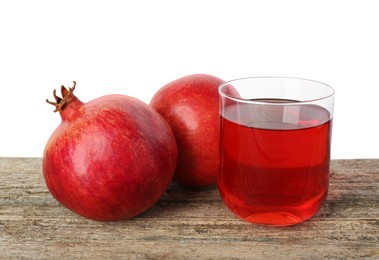 Photo of Refreshing pomegranate juice in glass and fruits on wooden table against white background