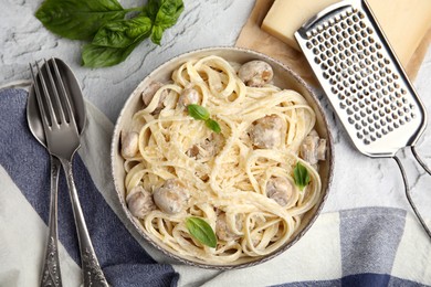 Photo of Delicious pasta with mushrooms and cheese served on light grey textured background, flat lay