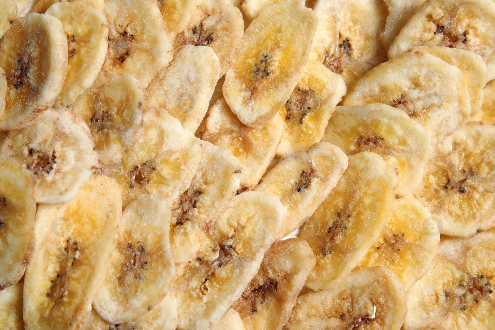 Photo of Sweet banana slices as background, top view. Dried fruit as healthy snack