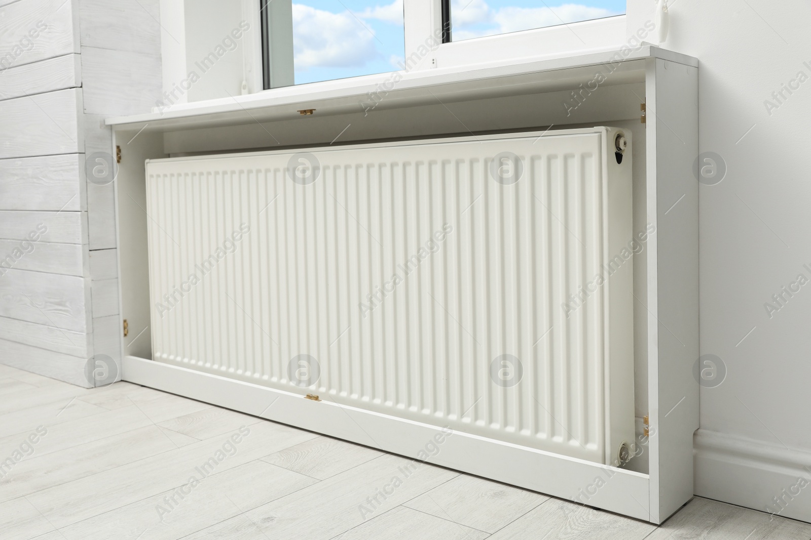 Photo of Modern radiator at home. Central heating system