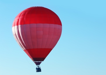 Photo of Beautiful view of hot air balloon in blue sky. Space for text