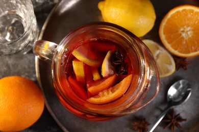 Photo of Jug of aromatic punch drink and ingredients on table, top view