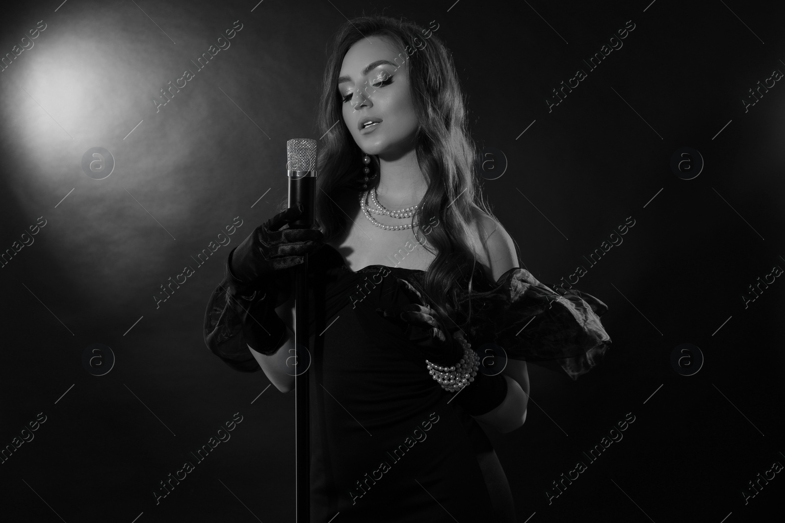 Image of Beautiful singer with microphone, black and white effect