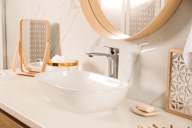 Photo of Stylish bathroom interior with vessel sink and decor elements