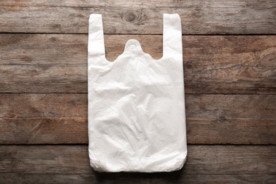 Photo of Clear disposable plastic bags on wooden background