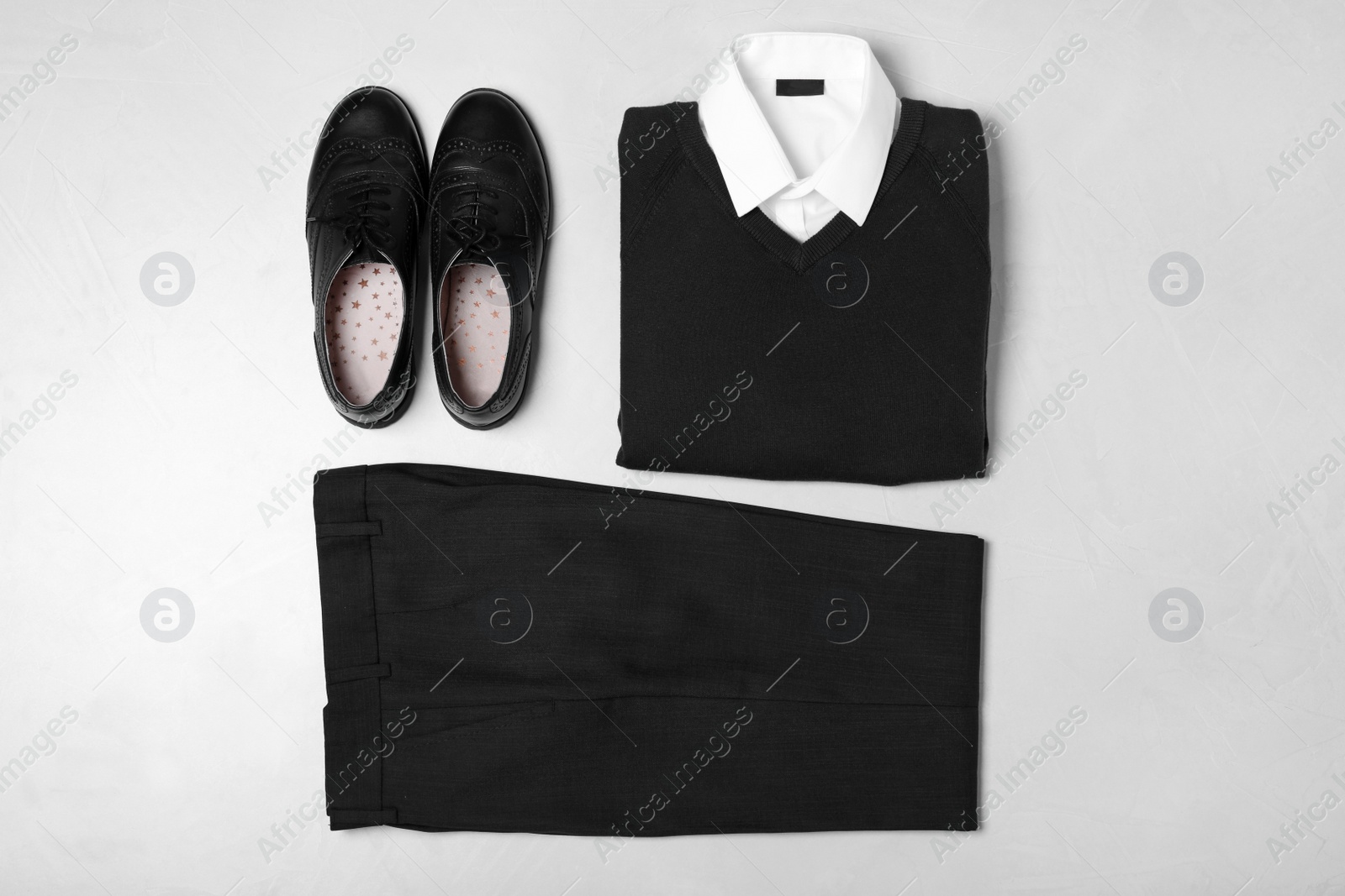 Photo of Flat lay composition with school uniform on light background