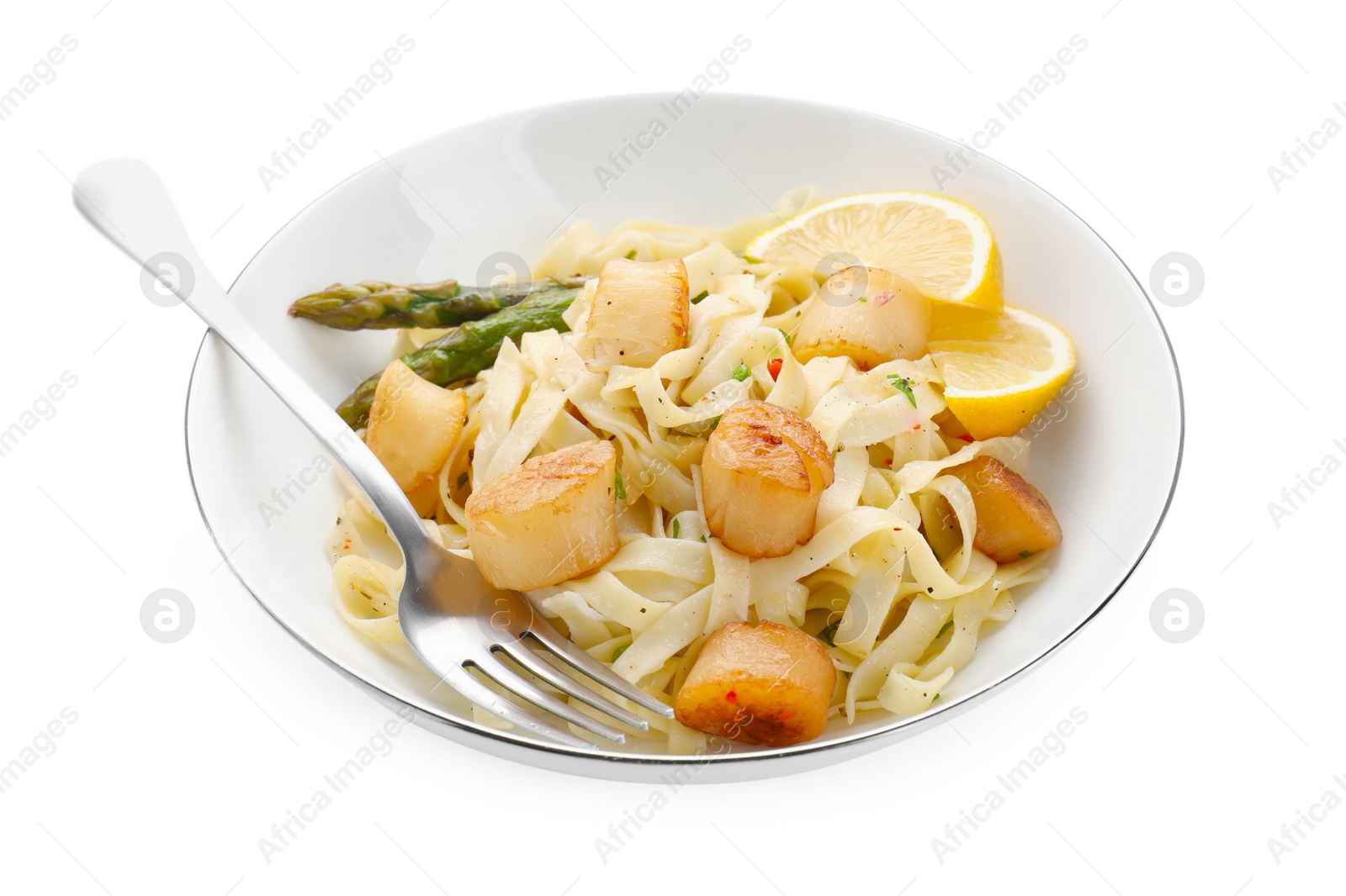 Photo of Delicious scallop pasta with asparagus, lemon and fork isolated on white