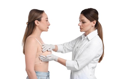 Mammologist checking woman's breast on white background