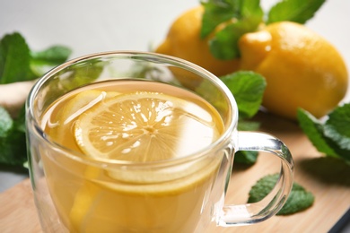 Glass cup with hot tea and lemon, closeup