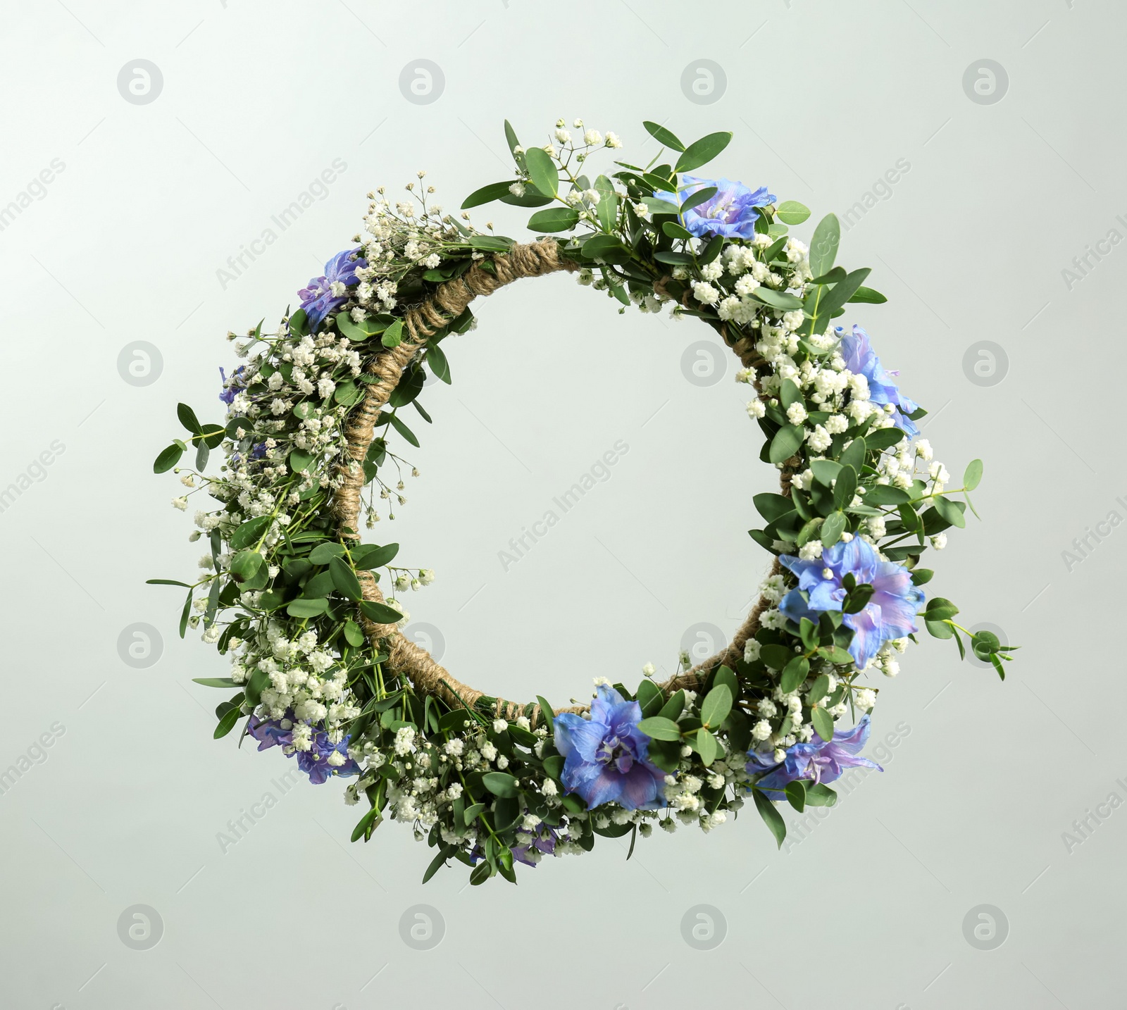 Photo of Beautiful handmade flower wreath on light background