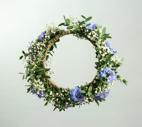 Beautiful handmade flower wreath on light background