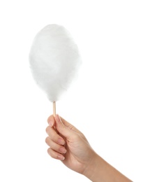 Photo of Woman holding stick with yummy cotton candy on white background, closeup