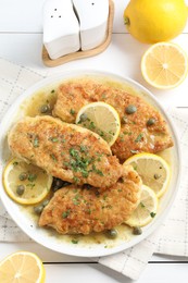 Photo of Delicious chicken piccata on white table, top view