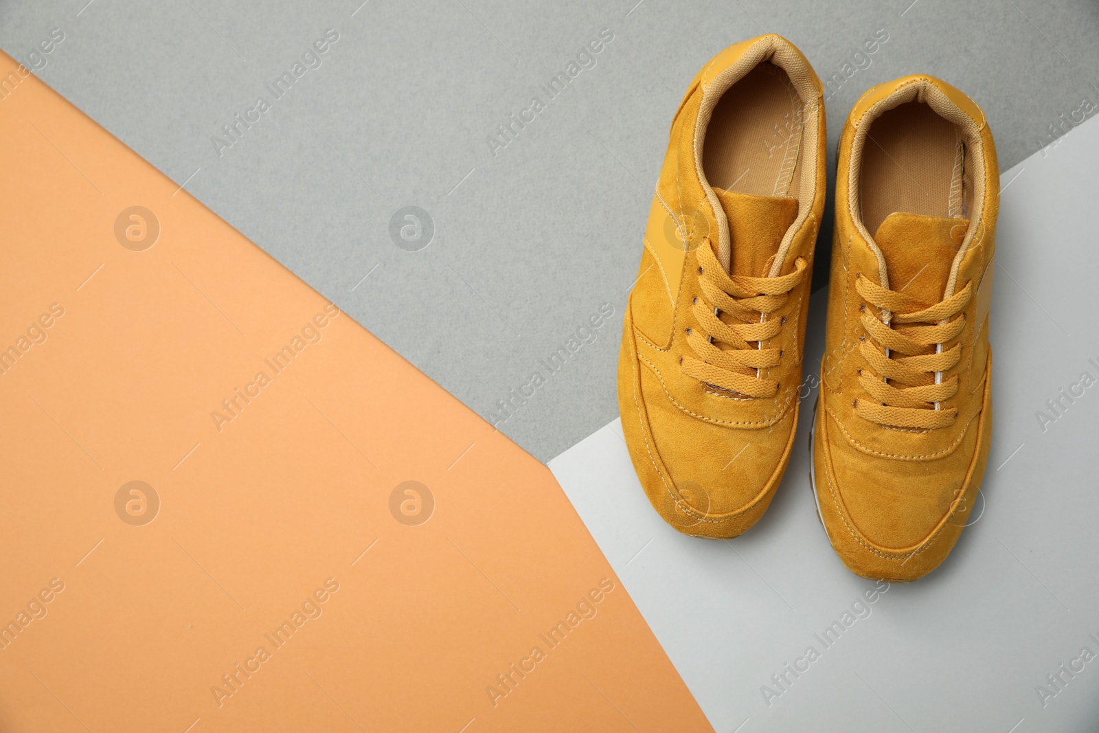 Photo of Stylish women's sneakers on color background, top view. Space for text