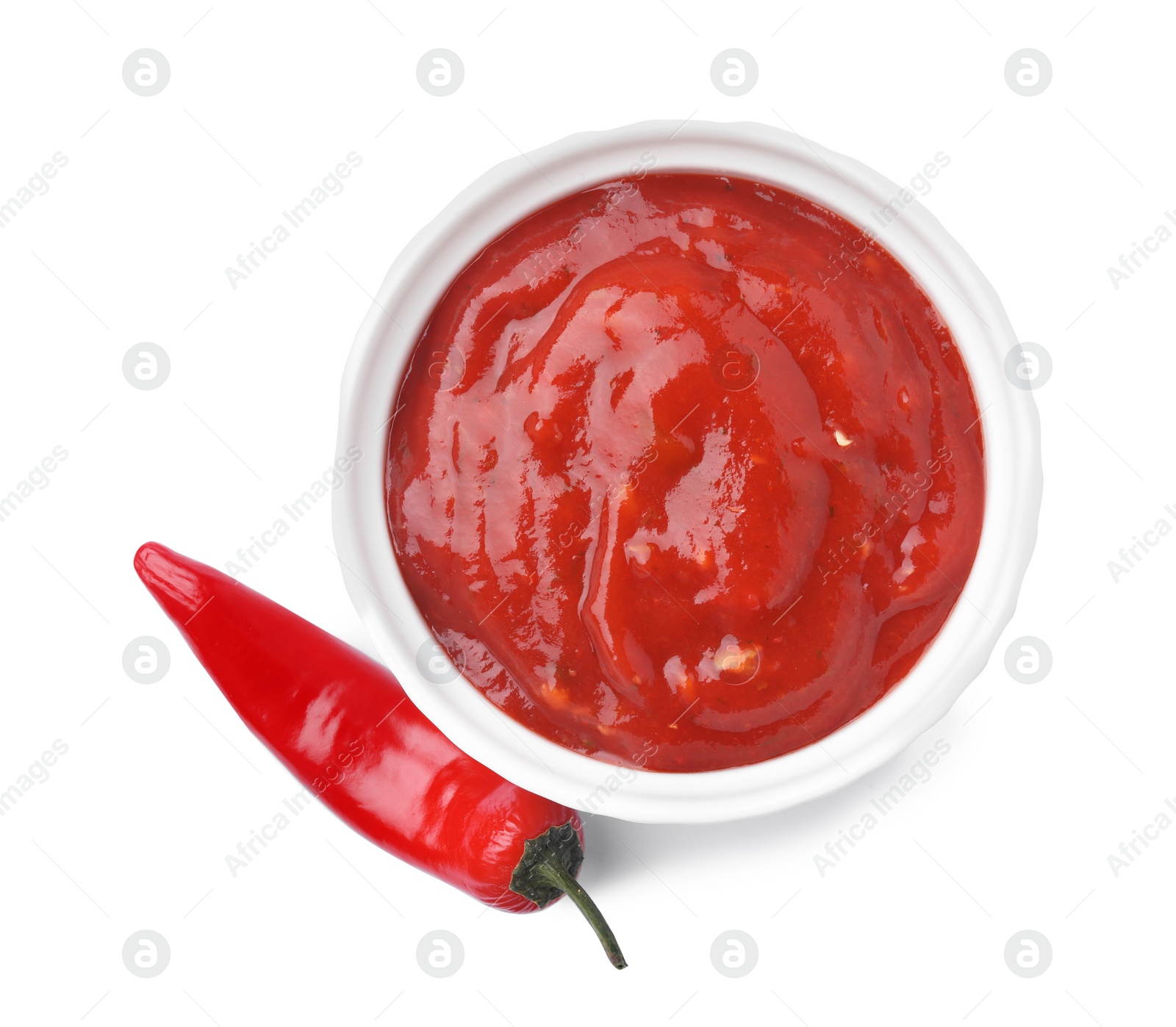 Photo of Bowl with red sauce and fresh chili pepper isolated on white, top view