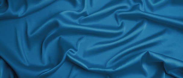 Image of Delicate blue silk as background, closeup view. Banner design