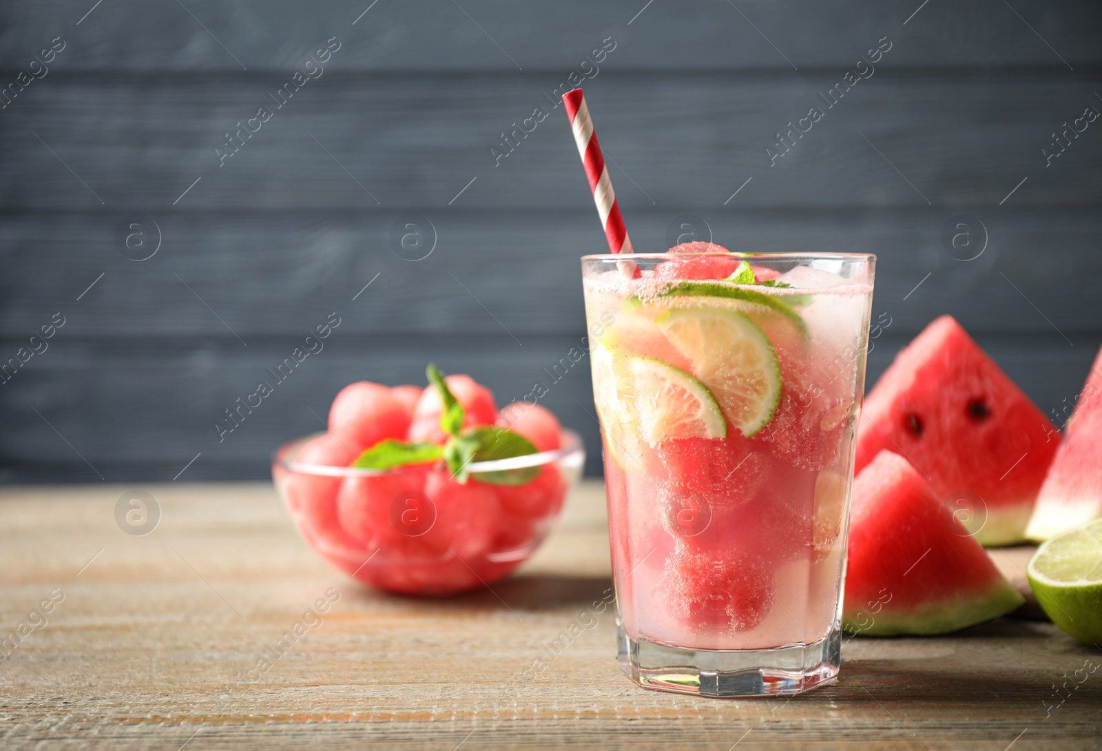 Photo of Glass of refreshing watermelon drink on wooden table. Space for text