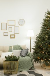 Beautiful Christmas tree with golden lights in living room