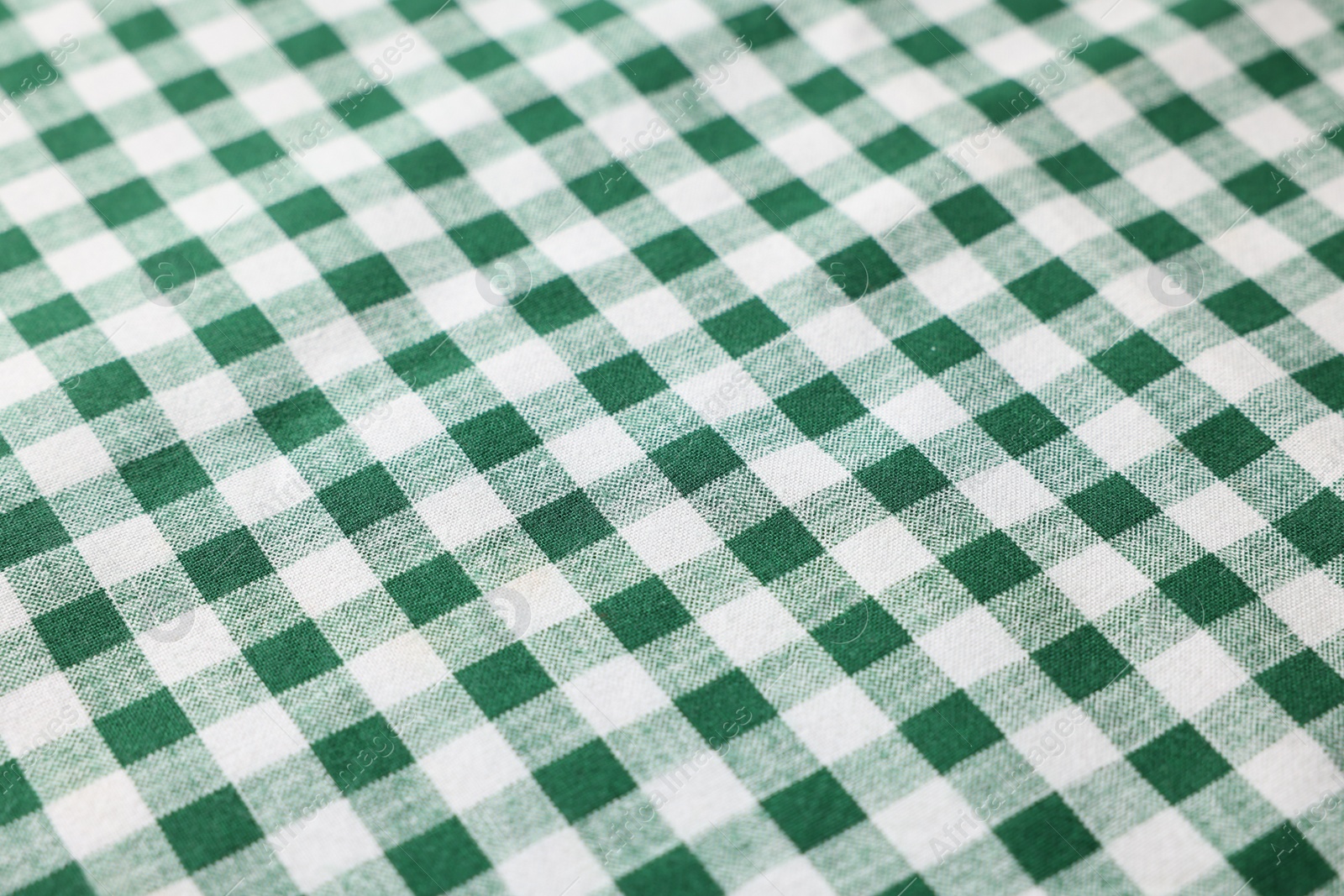 Photo of Green checkered tablecloth as background, closeup view