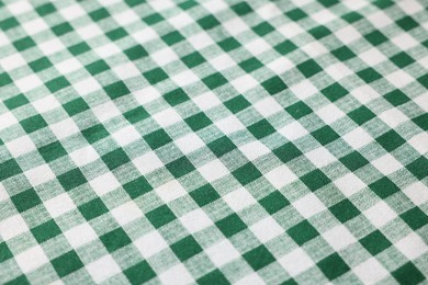 Photo of Green checkered tablecloth as background, closeup view