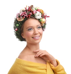 Beautiful young woman wearing Christmas wreath on white background