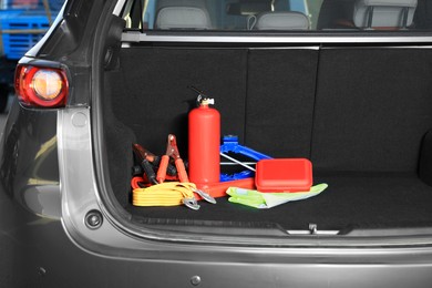 Photo of Set of car safety equipment in trunk, space for text